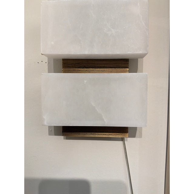 Stylish Revelation Triple Stacked Sconces. Triple white marble lights. Original Retail $909 each. Showroom floor sample.