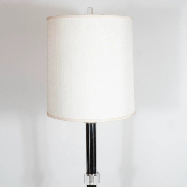 This refined floor lamp was realized in the United States, circa 1970. It features a cylindrical polished chrome body...