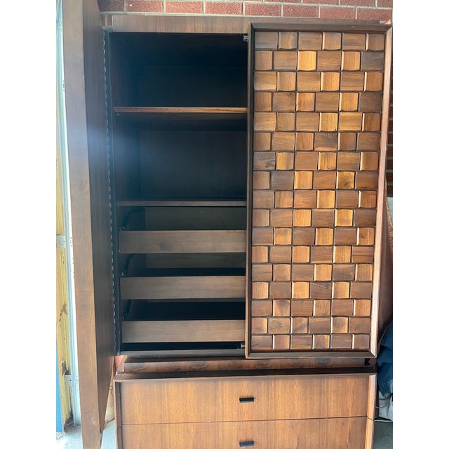 Tobago Brutalist Walnut Armoire / Wardrobe Cabinet — Mosaic Block Carved Doors, Made in Canada, c. 1960s–70s A commanding...