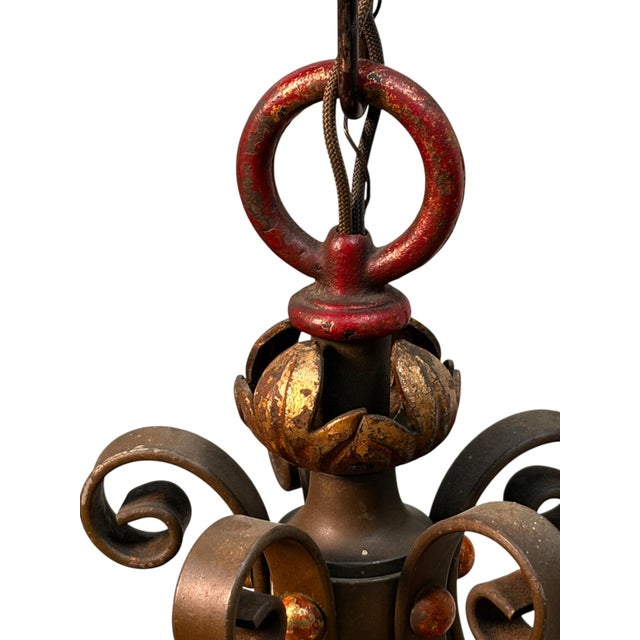 Large pendant light with four exposed bulbs surrounding it. Original paint finish is worn mostly on the top with some dark...