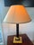 An elegant lamp with neoclassical accents, combining the rigor of the Empire style with the refinement of high-end 1980s...