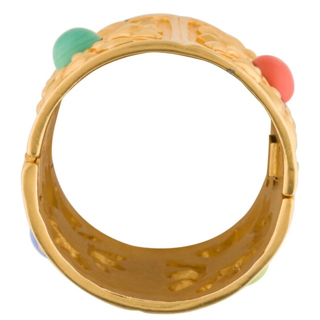Iconic cuff by Karl Lagerfeld. This collector’s cuff features signature Chanel gold plated finish and colorful Gripoix...