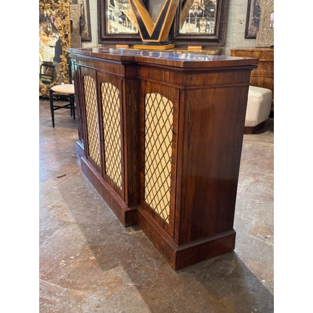 Handsome 19th century English rosewood and brass 4 door credenza. English rosewood and brass 4-door credenzas combine rich...
