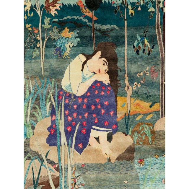 This early 20th-century Persian Tabriz pictorial carpet presents an elaborate figural scene set within a lush garden...