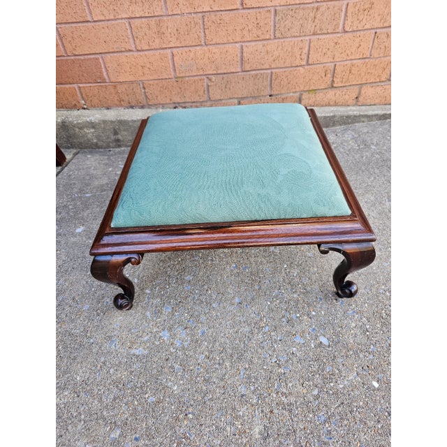 A Victorian Style Mahogany and Upholstered Footstool in great antique condition with newer upholstery. Measures 17.5"...