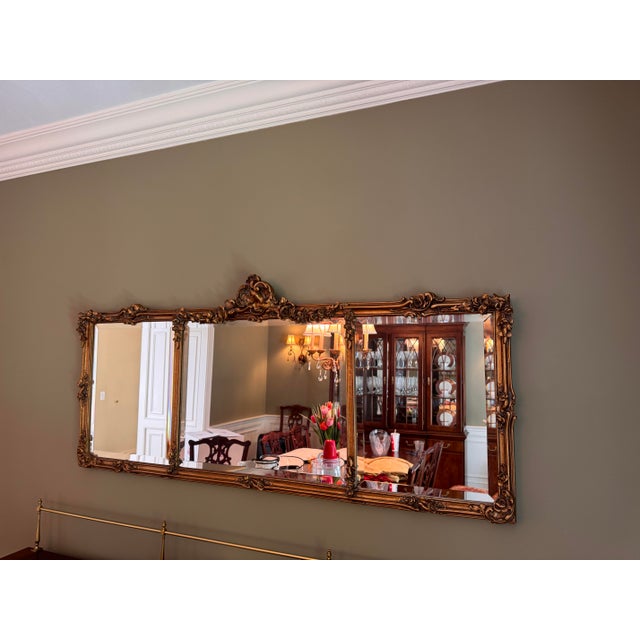 Has solid wood backing. This is an extra large horizontal ornate gold wall mirror designed in a French Baroque or Rococo...