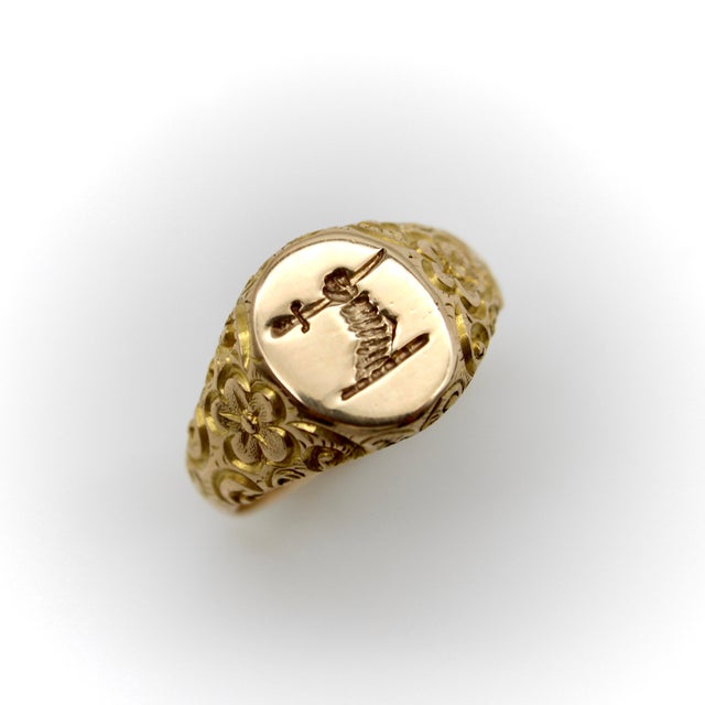 This beautifully carved 14k gold Victorian signet ring has the image of an arm holding a sword, ready for battle. The...