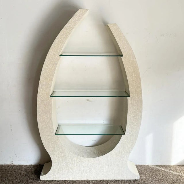 Enhance your living space with the unique and artistic Postmodern Sculpted White Stucco Etagere/Bookshelf. This bookshelf...