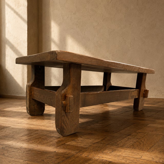 A large Brutalist coffee table from the 1970s, crafted from solid oak with thick wooden elements, exposed joinery details,...