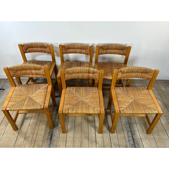 Set of six chairs in light elm. The four rectangular legs are joined by an H-shaped stretcher. The rear uprights form both...