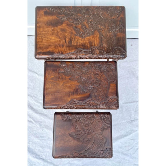 Here is an amazing set of 3 solid wood nesting tables that have been hand carved and crafted with stunning cherry blossom...