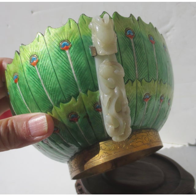 A fine specimen of zChinese enamel wares on a elaborately carved wooden display stand. Decorated to the exterior with...