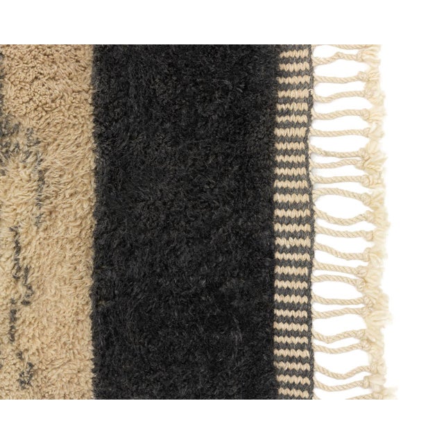 Elegant hand-knotted wool rug in a blend of Fawn and Charcoal hues, featuring a striking central Ivory hexagon pattern...