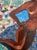 This is an original collage on wood panel, featuring a vibrant painted figure of a reclining nude woman with rich brown...