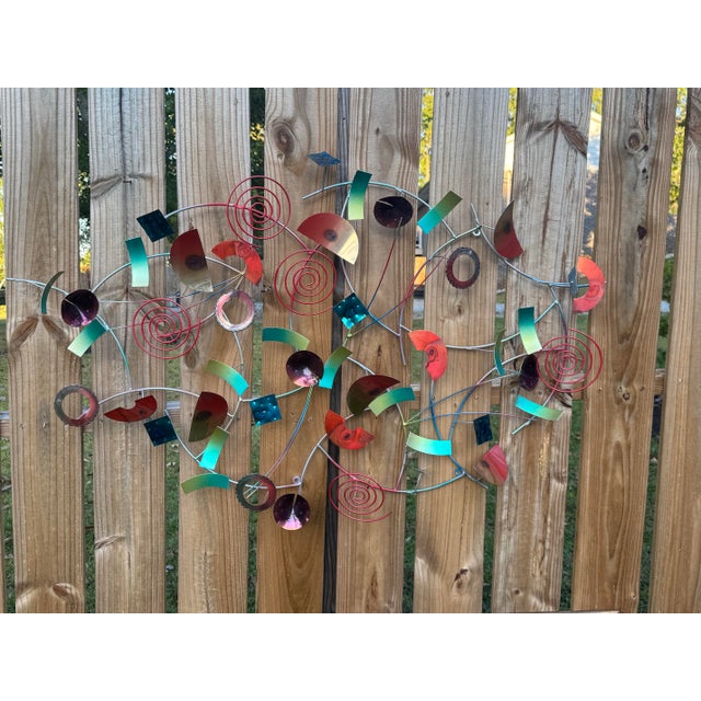 Colorful abstract metal wall sculpture by Artisan House, featuring an energetic arrangement of spirals, circles, squares,...