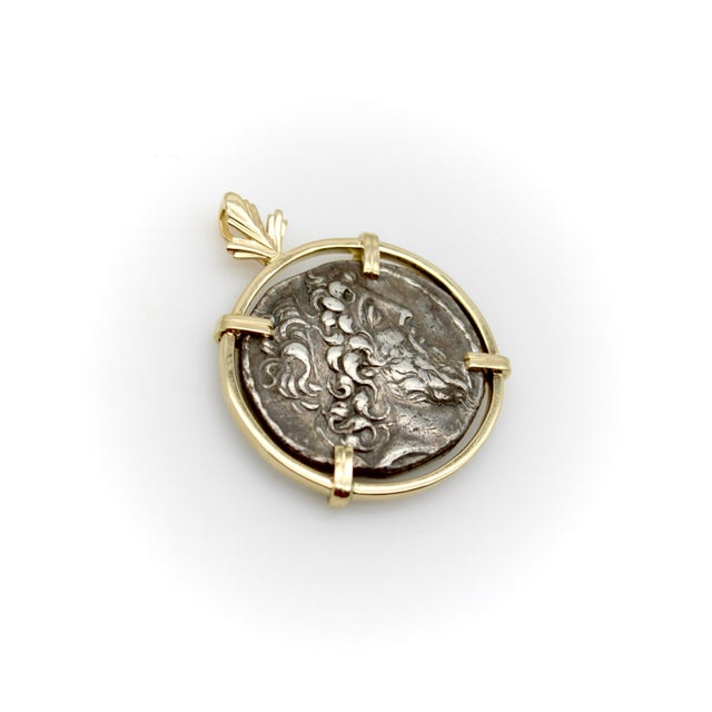 Housed in a 14k gold setting, the pendant features a sterling silver Tetradrachm coin that dates to 129-125 B.C. The front...