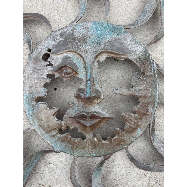 Large Tom Torrens Cast Sun. Will be listing several pieces by this sculptor. An Iron Bell, and a grouping of Palm Trees....