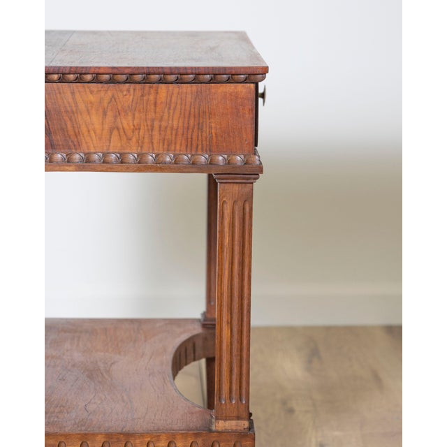 An elegant Italian side table in the Louis XVI style, dating from the 19th century and crafted in beautifully figured...