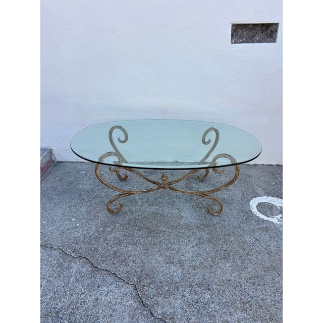 Hollywood Regency Vintage Hollywood Regency Style Coffee Table Featuring a Gold-Finished Wrought Iron Base With Scrollwork and an Oval Beveled Glass Top For Sale - Image 3 of 7