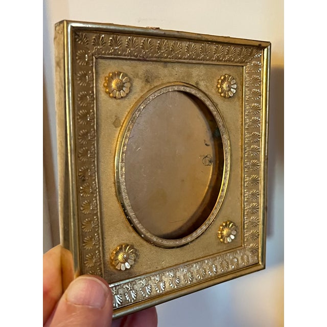 Antique 19th century French Empire ormolu small picture frame. Rectangular shape with oval reveal. Decorated with...