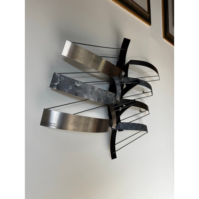 Striking 1993 Curtis Jere abstract wall sculpture crafted in a dynamic composition of mixed metals. This large-scale piece...