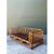 This vintage sofa is a long, low frame built from honey-toned rattan poles, with an airy diamond trellis filling the back...