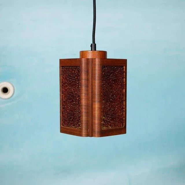 Very elegantly designed hanging lamp made of, among other things, ocher yellow bubble glass and curved teak wood....