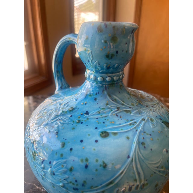 Glazed Ceramic Turquoise Blue Vase with floral accents and drops of 'confetti' in green and navy blue.