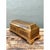 This vintage decorative box is entirely clad in brass over a wood core, its elongated rectangular form rising to a gently...