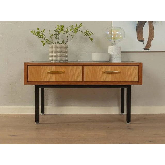 Classic chest of drawers from the 1960s. High-quality body in teak veneer with two drawers in ash veneer and square steel...