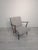 Mid-Century Scandinavian Armchair This stylish mid-20th-century Scandinavian armchair features dark wooden legs and an...