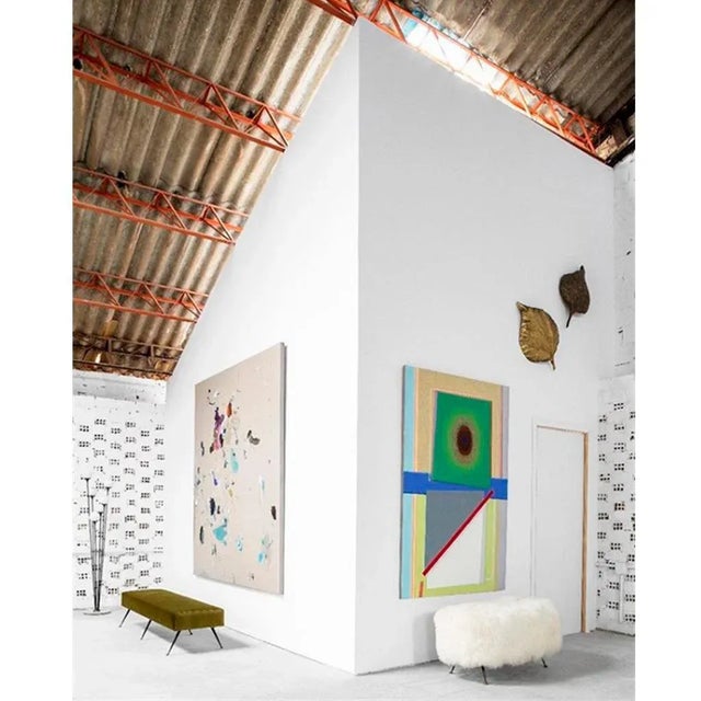 Italian footstool upholstered in natural white Mongolian goat´s fur. Base made of solid wood with metal legs.