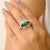 Make a statement with this striking front-open dinner ring, crafted in sterling silver and adorned with a vibrant green...