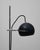A striking example of mid-century French design, this adjustable metal table lamp features a sleek black domed shade...