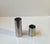 A set of 2 cylindrical holders for kitchen or desk utensils. Made from stainless steel and has a base in black plastic....