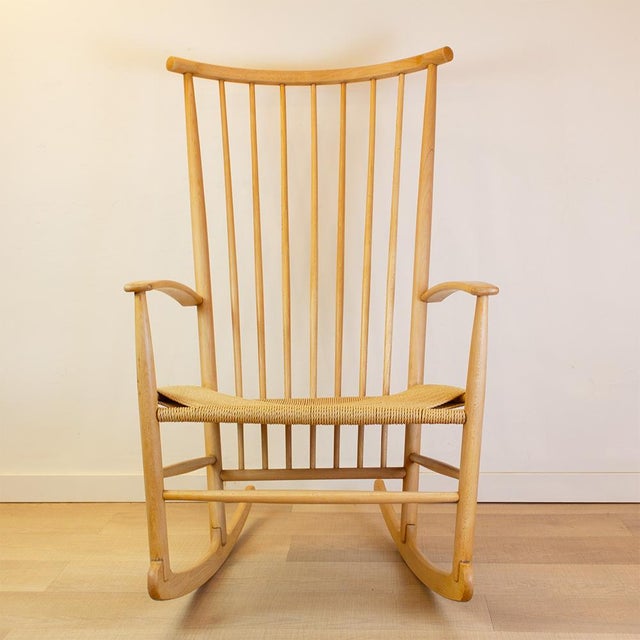 Vintage Scandinavian wooden rocking chair with spindle backrest in the style of Hans Wegner. Manufactured in the 1960s in...