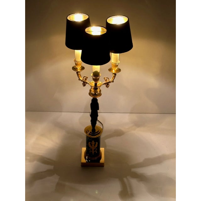 Ornate and elegant Empire style table lamp having patinated bronze figural goddess form with marblized base.