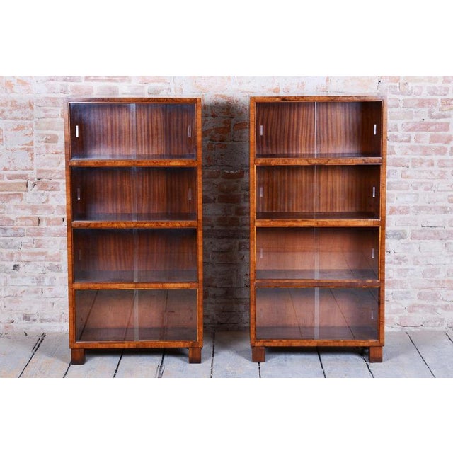 This elegant pair of Art Deco bookcases comes from the early 20th century. They are made of walnut wood and have sliding...