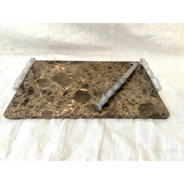 Atticus Marble and Chrome Cheese Board w/Knife. Has a faux bamboo chrome handles and brown tones in marble. Perfect for 2...