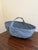 A large American splint oak gathering basket with woven twig handle, painted in a gorgeous pale blue. The charming basket...