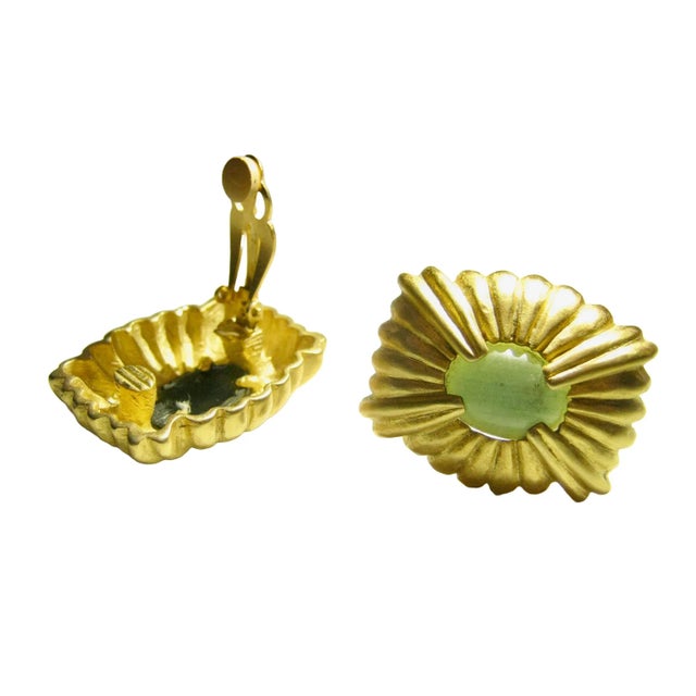 This is part of Chairish's Costume Jewelry Collection. Givenchy gorgeous carved Matte gild peridot glass clip back...