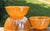 A striking set of three vintage Anchor Hocking Fire-King Peach Lustre Swirl nesting mixing bowls, dating to the mid-20th...