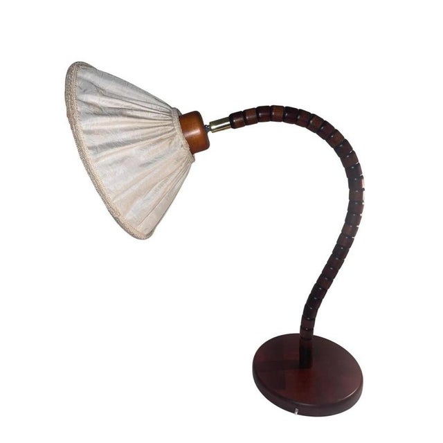 Beautiful table lamp ''Swan neck'' in pine with brass detail made by Markslöjd, Sweden in the 1970's. Adjustable shade....