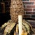 This is a Hollywood Regency era Italian pineapple chandelier with six arms. It is comprised of tole metal leaves and wood...