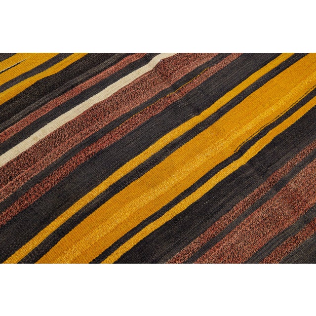 Beautiful Vintage Kilim hand-knotted wool rug with multicolor accents in an all-over geometric stripe design. This rug...