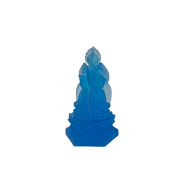 This translucent sky-blue glass statuette features a traditional three-sided design (Sanbao Fo), showcasing three distinct...
