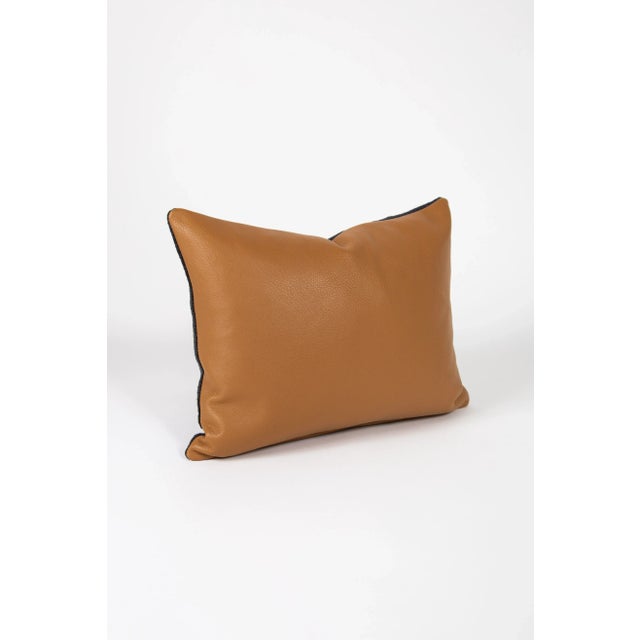 Soft tan leather is paired with a simple navy and black patterned fabric to make this pillow a show stopper. No matter...