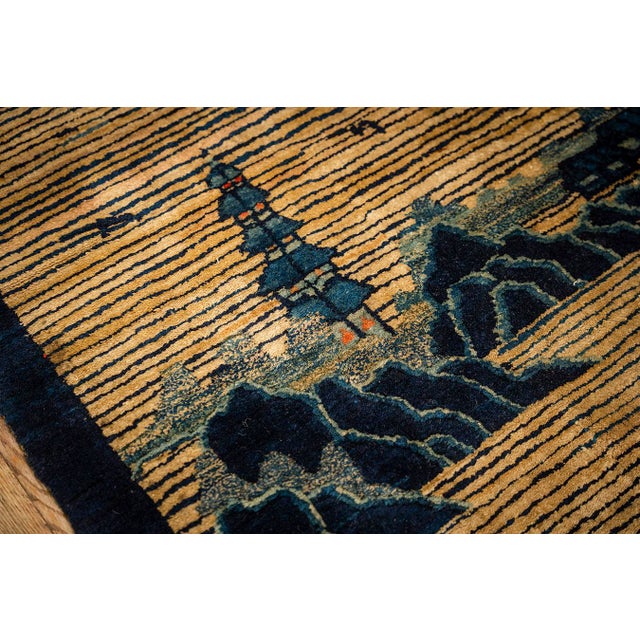 This antique rug is a classic Chinese Peking piece from circa 1920, featuring a refined and understated color palette. The...