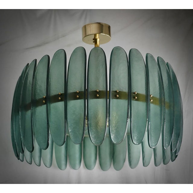 Fantastic round chandelier in Murano glass and polished brass. Note the shape of the half shells in green Murano glass,...