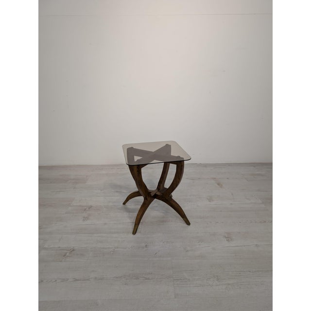 Spider-Leg Mid-Century Italian Lava Table This stylish Italian coffee table, known as Spider-Leg, features a carved wooden...